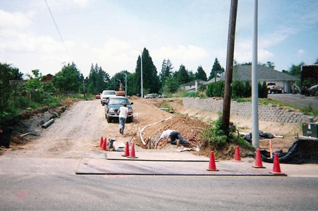 Water main utility connection being installed